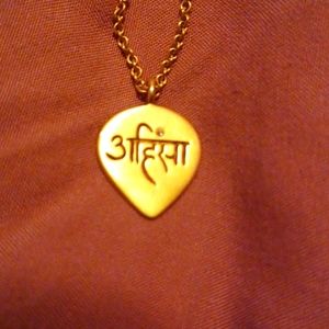 18K yellow gold Me&Ro Ahimsa pendant necklace.